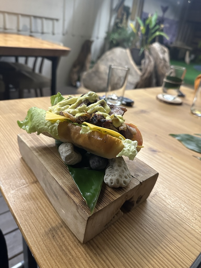 Wagyu bao plated on stones over a raw wood board