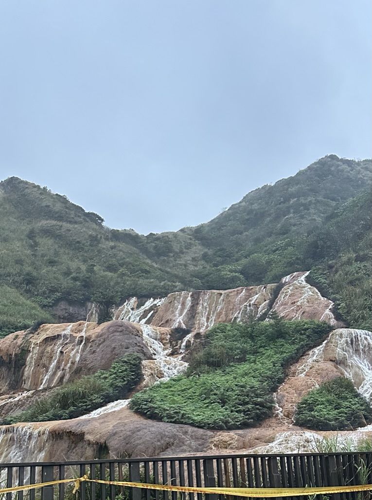 Golden mineral waterfall in the mountains near Jiu Fen