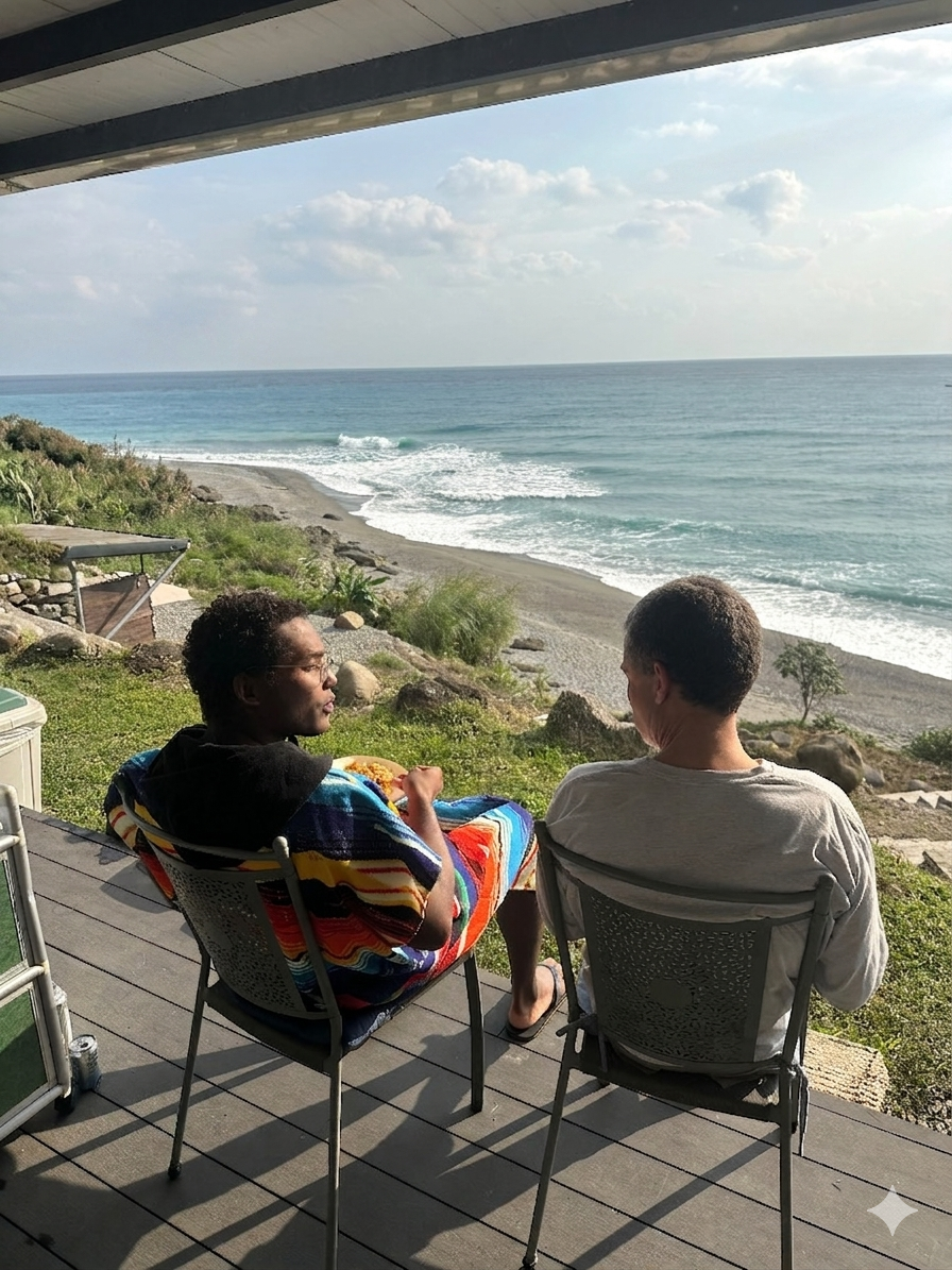 Two guests watching the Pacific from a shaded deck