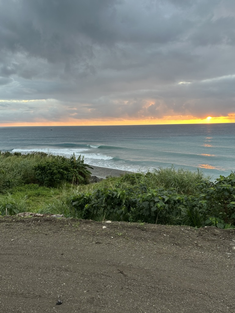 Sunrise breaking over the Pacific with clean lines of swell