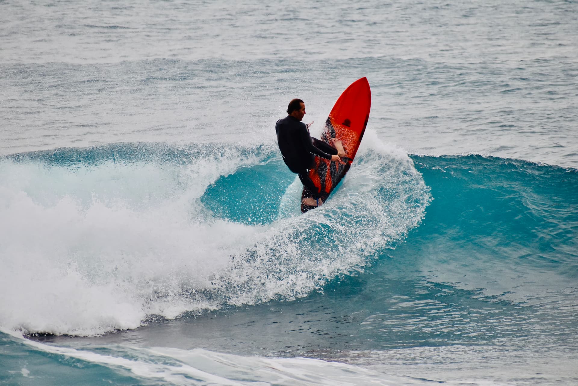 Brent driving off the top of a turquoise wave