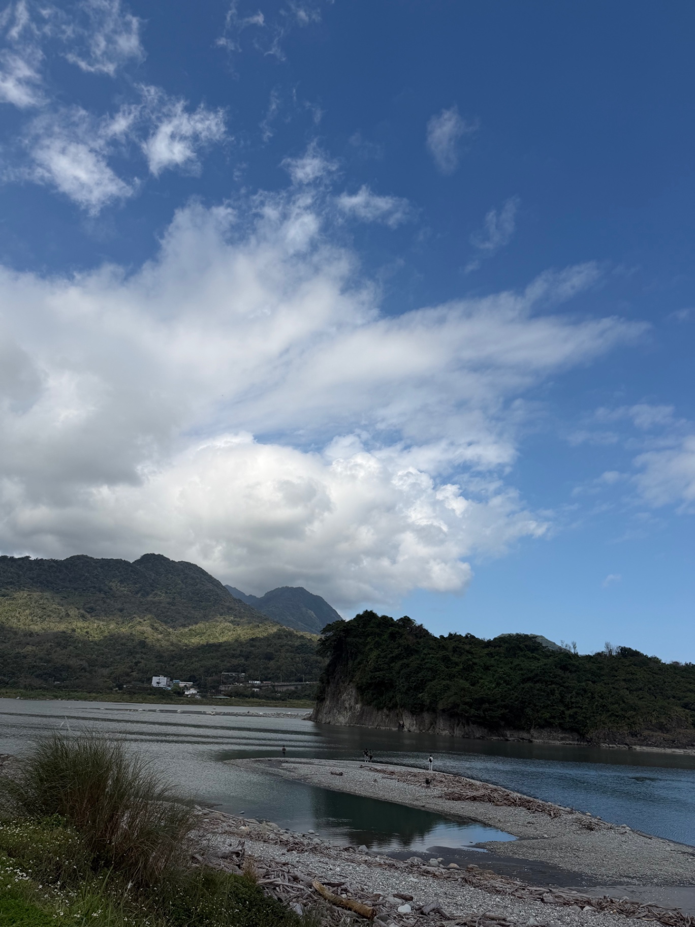 River mouth opening to the Pacific beneath jungle mountains