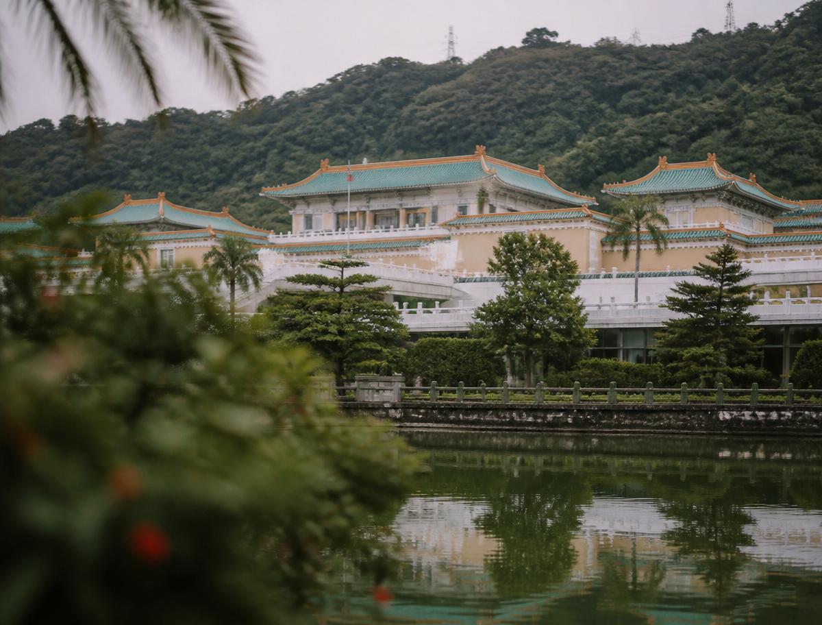 National Palace Museum in Taipei, traditional Chinese architecture reflected in a calm garden pool